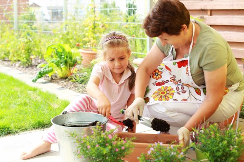 Worker using protective gear while operating powered garden equipment
