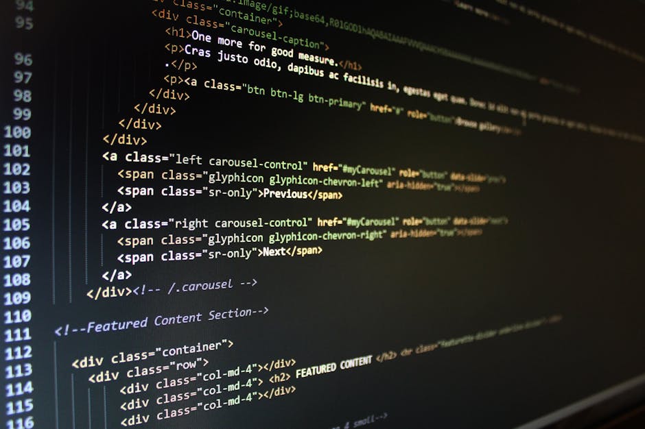 A detailed close-up photograph of a computer screen displaying HTML and CSS code, with syntax highlighting in various colors including green, yellow, and white on a dark background. The code includes 